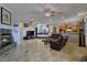 Open floor plan with tile floors, fireplace, and access to the kitchen and dining areas at 5445 Pendini Point Ct, Las Vegas, NV 89141