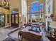 Bright living room boasts high ceilings, large windows, and a cozy fireplace for a luxurious living experience at 5445 Pendini Point Ct, Las Vegas, NV 89141