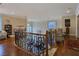 Elegant loft features hardwood floors, wrought iron railing, and views to the main living areas at 5445 Pendini Point Ct, Las Vegas, NV 89141