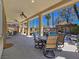 Covered patio with ample seating overlooks the pool, spa and outdoor kitchen area at 5445 Pendini Point Ct, Las Vegas, NV 89141