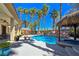 Backyard featuring pool with rock waterfall, tiki bar and built in barbecue at 5445 Pendini Point Ct, Las Vegas, NV 89141