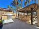 The backyard features a tiki bar and stainless steel barbecue at 5445 Pendini Point Ct, Las Vegas, NV 89141