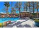 Serene pool with rock waterfall feature, spa and shady tiki bar with seating at 5445 Pendini Point Ct, Las Vegas, NV 89141