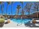 Stunning pool area with rock waterfall feature, covered hot tub, and patio seating, perfect for entertaining at 5445 Pendini Point Ct, Las Vegas, NV 89141