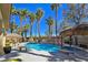Beautiful pool with rock features, a spa, and a tiki bar creates a relaxing outdoor space at 5445 Pendini Point Ct, Las Vegas, NV 89141