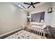 Cozy bedroom featuring a vaulted ceiling, ceiling fan, unique decor, and neutral paint at 5638 Wild Olive St, Las Vegas, NV 89118