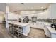 Modern kitchen with an island, white cabinets, stainless steel appliances, and tile backsplash at 5638 Wild Olive St, Las Vegas, NV 89118