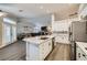 Modern kitchen with a large island, white cabinets, stainless steel appliances, and plenty of counter space at 5638 Wild Olive St, Las Vegas, NV 89118