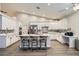 This kitchen showcases white cabinets, an island with seating, and stainless steel appliances at 5638 Wild Olive St, Las Vegas, NV 89118