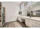 Main bathroom featuring double sinks, soaking tub, and a separate glass enclosed shower at 5638 Wild Olive St, Las Vegas, NV 89118
