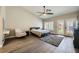 The main bedroom features vaulted ceilings, wood-look floors, and access to the backyard at 5638 Wild Olive St, Las Vegas, NV 89118