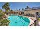 Backyard with a sparkling pool, rock waterfall, and solar panels on the home's roof at 5638 Wild Olive St, Las Vegas, NV 89118