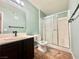 Bathroom featuring single sink vanity, toilet, and glass-enclosed shower at 5710 E Tropicana Ave # 1055, Las Vegas, NV 89122