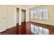 Bedroom featuring hardwood floors, a bright window, and large closets with sliding doors at 5710 E Tropicana Ave # 1055, Las Vegas, NV 89122