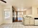 Bright kitchen with white cabinets, tile floors, and an adjoining living area at 5710 E Tropicana Ave # 1055, Las Vegas, NV 89122