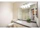 Bright bathroom featuring a granite countertop, a large mirror, and a shower with glass doors at 6160 Rumrill St # 121, Las Vegas, NV 89113