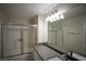Bright bathroom featuring a shower-tub combo with sliding glass doors and granite countertops at 6160 Rumrill St # 121, Las Vegas, NV 89113