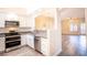 Modern kitchen featuring stainless steel appliances, granite countertop, and an open view to living area at 6160 Rumrill St # 121, Las Vegas, NV 89113