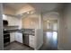 Modern kitchen with stainless steel appliances, gray countertops, and open view to living area at 6160 Rumrill St # 121, Las Vegas, NV 89113