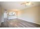 Living room showcases wood-look flooring, open layout, modern fan, and dining room view at 6160 Rumrill St # 121, Las Vegas, NV 89113
