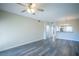 Open-concept living room features wood-look flooring, arched doorways, and a modern ceiling fan at 6160 Rumrill St # 121, Las Vegas, NV 89113