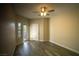Bright main bedroom featuring hardwood floors, a ceiling fan, and private entry to the backyard at 6160 Rumrill St # 121, Las Vegas, NV 89113