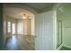 Spacious main bedroom with hardwood floors, ceiling fan, and access to a bathroom at 6160 Rumrill St # 121, Las Vegas, NV 89113