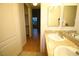 Bright bathroom featuring double sinks with granite counters and mirrored cabinets at 62 E Serene Ave # 129, Las Vegas, NV 89123
