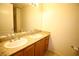 Bathroom featuring double sinks, granite countertops and a large mirror at 62 E Serene Ave # 129, Las Vegas, NV 89123