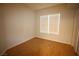 Bright bedroom with hardwood flooring and a large window at 62 E Serene Ave # 129, Las Vegas, NV 89123