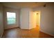 Bright bedroom featuring hardwood floors and a window with a view at 62 E Serene Ave # 129, Las Vegas, NV 89123