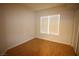 Bright bedroom with hardwood flooring and a large window at 62 E Serene Ave # 129, Las Vegas, NV 89123