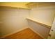 Organized closet with wooden shelves, closet rod and laminate floors at 62 E Serene Ave # 129, Las Vegas, NV 89123