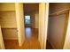 Spacious walk-in closet with wooden shelving and laminate floors at 62 E Serene Ave # 129, Las Vegas, NV 89123