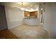 Open-concept dining area with tile flooring and an archway leading to the kitchen at 62 E Serene Ave # 129, Las Vegas, NV 89123