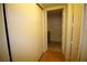 Hallway leading to a bathroom with sliding closet doors and hardwood floors at 62 E Serene Ave # 129, Las Vegas, NV 89123