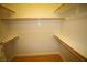 Spacious walk-in closet with custom shelves and hardwood floors at 62 E Serene Ave # 129, Las Vegas, NV 89123