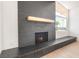Contemporary fireplace with gray brick and a decorative mantel, perfect for cozy evenings at 6205 Hargrove Ave, Las Vegas, NV 89107