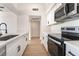 Modern kitchen with stainless steel appliances, quartz countertops, and ample cabinet space at 6205 Hargrove Ave, Las Vegas, NV 89107