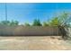 A sun-drenched backyard featuring a block wall and desert landscaping at 6829 Painted Morning Ave, Las Vegas, NV 89142