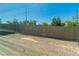 A sun-drenched backyard featuring a block wall and desert landscaping at 6829 Painted Morning Ave, Las Vegas, NV 89142