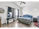 Bright bedroom featuring a vaulted ceiling, wood look floors and several windows at 6829 Painted Morning Ave, Las Vegas, NV 89142