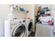 Well-organized laundry room equipped with a front-load washer and dryer, shelving, and storage solutions at 6829 Painted Morning Ave, Las Vegas, NV 89142