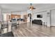 Open concept living room and kitchen with hardwood floors, stainless appliances, and a seamless design at 6829 Painted Morning Ave, Las Vegas, NV 89142