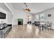 Spacious living room featuring hardwood floors, ceiling fan, and ample natural light at 6829 Painted Morning Ave, Las Vegas, NV 89142