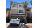 Charming two-story home features a stucco exterior, arched windows, and a well-manicured front yard at 6877 Philharmonic Ave, Las Vegas, NV 89139