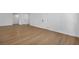 Open basement area with wood-look flooring and white paneled doors at 6939 Paddington Way, Las Vegas, NV 89147