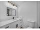 Well-lit bathroom with marble countertop vanity, modern fixtures, and a toilet at 6939 Paddington Way, Las Vegas, NV 89147