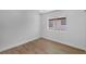 Bright, empty bedroom with wood-look flooring and a view to the exterior at 6939 Paddington Way, Las Vegas, NV 89147