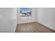 Bright bedroom with wood-look flooring and window showing exterior view at 6939 Paddington Way, Las Vegas, NV 89147